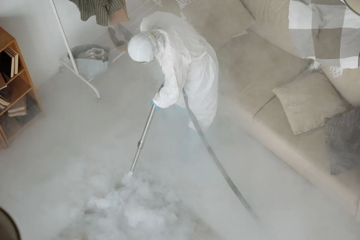Biohazard cleanup technician in protective equipment, Williamsburg, IA